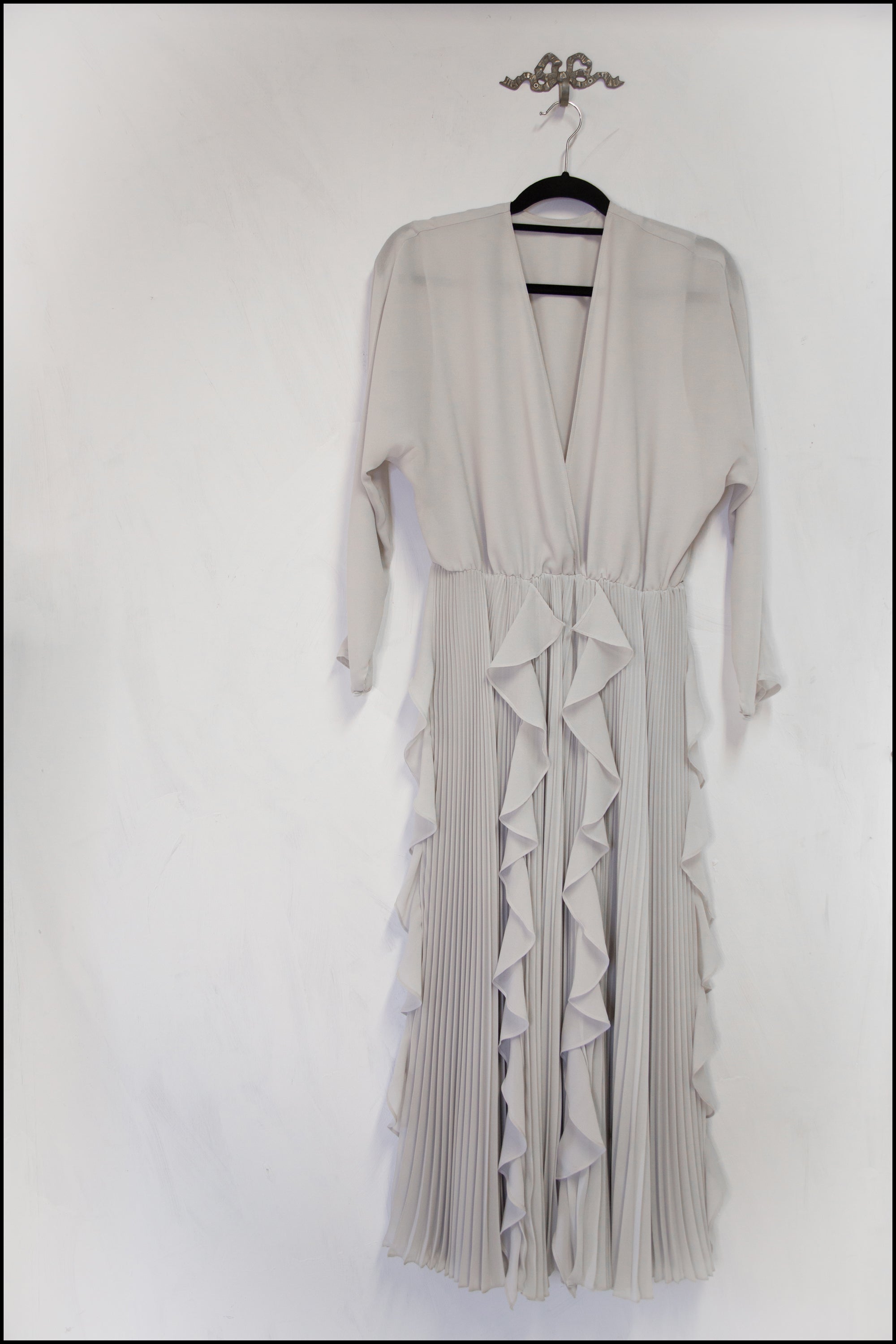 vintage grey pleated dress on hanger