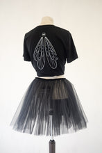 Black t-shirt with fairy wing design on a mannequin wearing a black tutu skirt.