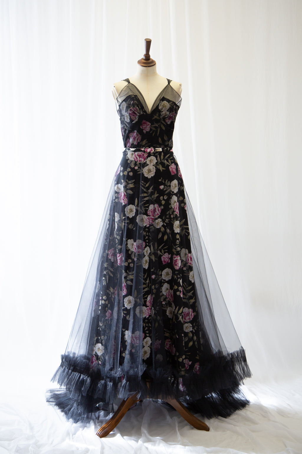 Black floral tulle evening gown on a mannequin against a white background by Alexandra King