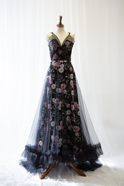 Black floral tulle evening gown on a mannequin against a white background by Alexandra King