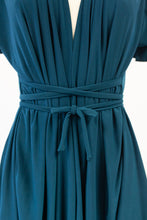 Teal dress with a tie waist on a white background