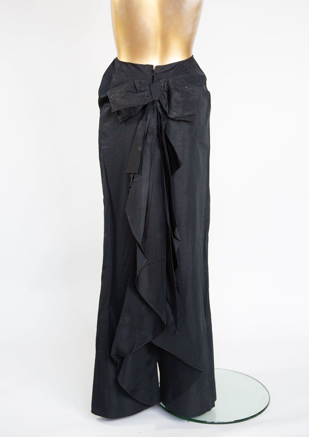 Vintage Edwardian black taffeta evening skirt with a high cinched waist and a bow bustle at the back, displayed on a mannequin.
