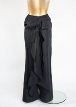 Vintage Edwardian black taffeta evening skirt with a high cinched waist and a bow bustle at the back, displayed on a mannequin.