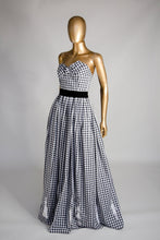 Black and white gingham cotton ballgown dress with applique people hem, displayed on a mannequin.